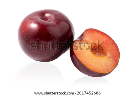 Dark red plum and half of a plum isolated on a white background.Ripe bright fruit on a white background.