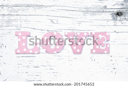 the word love on a white background worn