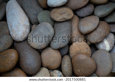 River rocks of various colors, rounded shape.