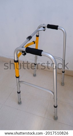 Angle view of folding walker with grey and yellow color. 