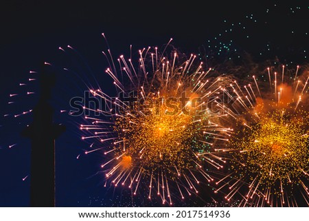 Holiday fireworks with sparks, colored stars and bright nebula on black night sky universe, comets. Amazing beauty colorful fireworks display on celebration, showing on city. Celebrate backgrounds