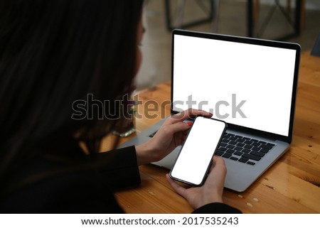 Closed up with Asian businessman using cellphone in front of laptop computer, empty screen of smart phone and laptop. Royalty-Free Stock Photo #2017535243