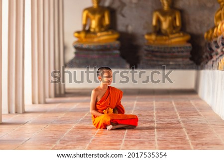 Young novice monk sitting for meditation at Wat Phutthaisawan temple, Ayutthaya, Thailand Royalty-Free Stock Photo #2017535354