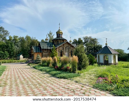 Small wooden Orthodox church in the garden.