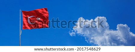 Turkish flag on cloudy sky background 