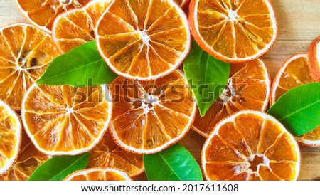 Dried orange slices on the wooden table. Dry citrus. Dried citrus fruits on the table. Orange slices top view. Still life citrus fruits photography. Royalty-Free Stock Photo #2017611608