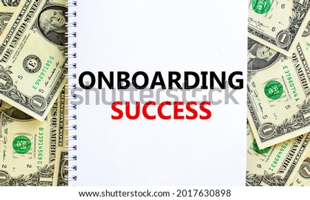 Onboarding success symbol. Words 'Onboarding success' on white note. Beautiful background from dollar bills. Business, onboarding success concept. Copy space.