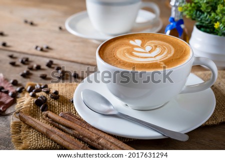 Cappuccino coffee in a beautiful glass on the table favorite cup of coffee concept. Royalty-Free Stock Photo #2017631294
