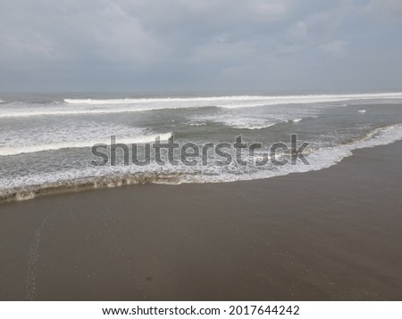 Beautiful beach waves and sea water splashing to the beach form drone aerial shot, at Bengkulu