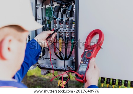 The inspector checks the actual output voltage level of inverter Royalty-Free Stock Photo #2017648976