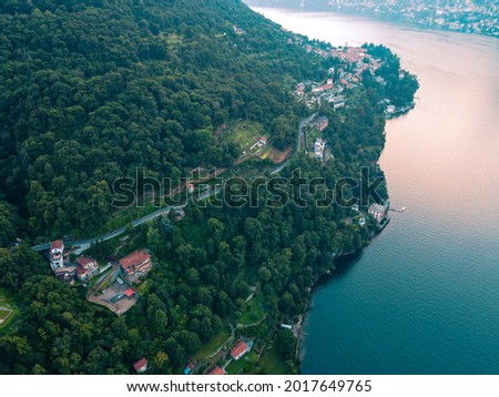 Aerial view of the village of Torno in Italy, Lake Como, Lombardy, Italian Lakes. Drone photography and birds eye of Torno, near Como and Lecco, in Brianza. Boats parked off the coast in an old port.