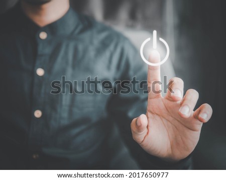 Finger press a power button.Energy saving concept. Royalty-Free Stock Photo #2017650977