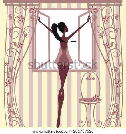 Girl standing at the window 