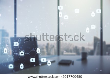 Double exposure of creative abstract medical hologram and modern desktop with laptop on background. Healthcare technolody concept