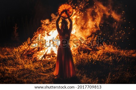 beautiful shamanic girl playing on shaman frame drum in the nature. Royalty-Free Stock Photo #2017709813