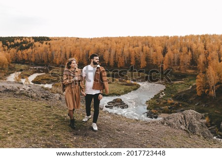 Happy couple in love newlyweds in casual clothes travel together, hike and walk in the autumn forest in nature, selective focus Royalty-Free Stock Photo #2017723448