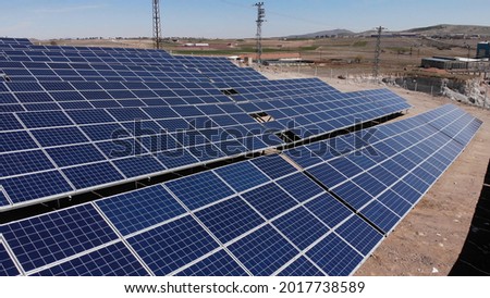 Aerial view of close up solar power panels, in desert. Royalty-Free Stock Photo #2017738589