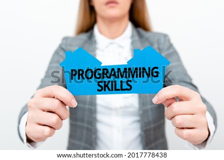 Text caption presenting Programming Skills. Business approach skills vital to write a program so computer can process A Young Lady Businesswoman Holding Presenting Home In Business Outfit
