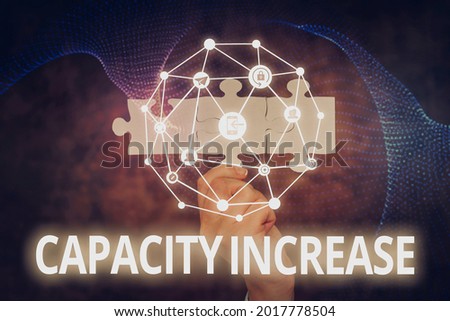 Handwriting text Capacity Increase. Word Written on meet an actual increase in demand, or an anticipated one Hand Holding Jigsaw Puzzle Piece Unlocking New Futuristic Technologies.