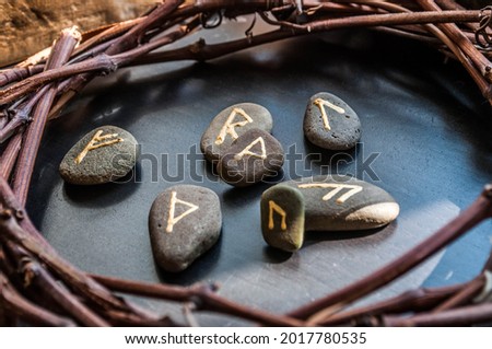 Rune stones on a wooden table. Future reading concept. Royalty-Free Stock Photo #2017780535