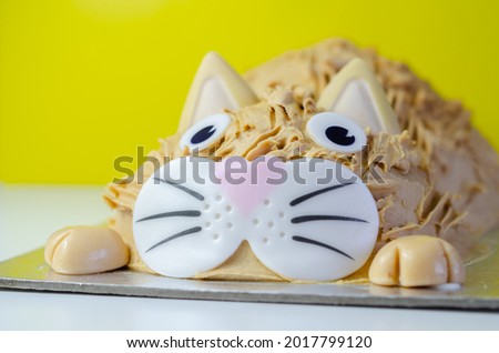 Cake cat,madeira sponge, layered and coated with caramel flavour frosting, finished with edible sugar decorations, birthday cake
