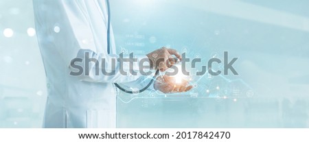 Doctor hold stethoscope on virtual medical network icons. Covid-19 pandemic develop people awareness and spread attention on healthcare, rising growth in hospital and health insurance business.