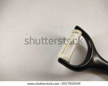 abstract defocused photo of fruit peeler isolated on white background