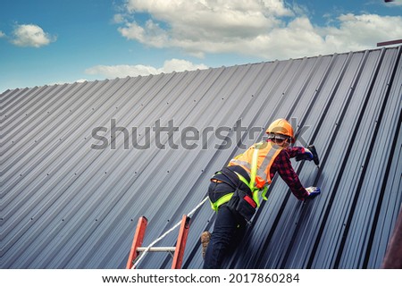 Worker man building tradesman on the roof of a house 
 with safety helmet, new home, construction concepts - Selective focus.
vintage film grain filter effect styles Royalty-Free Stock Photo #2017860284