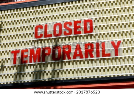 Closed Temporarily sign on a movie cinema billboard.