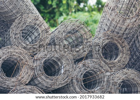 Mesh wire rolls of iron stainless steel, galvanized metal sheets construction material. Chicken wire mesh rolls farm fence. Net wire mesh roll engineer Construction galvanize malleable steel storage Royalty-Free Stock Photo #2017933682