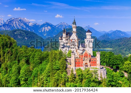 Neuschwanstein Castle, Germany. Front view of the castle with the Bavarian Alps in the background.