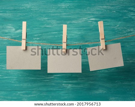 paper cards hanging on a rope on a wooden background