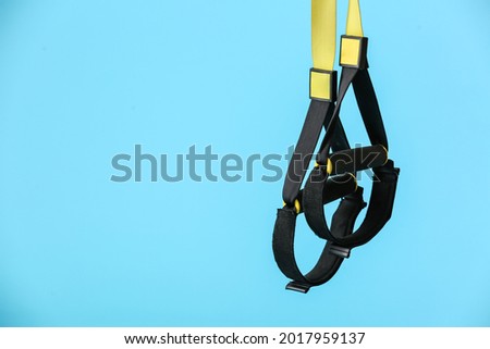 TRX straps on color background