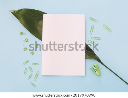 Composition with blank magazine on color background