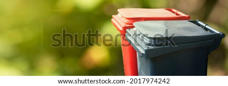 Two trash bin on green nature background. Separate and sorting garbage. Recycling and storage of waste for further disposal, trash sorting concept Royalty-Free Stock Photo #2017974242