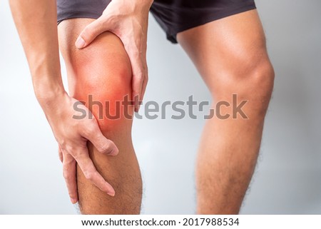 man with muscle pain on grey background. Elderly have knee ache due to Runners Knee or Patellofemoral Pain Syndrome, osteoarthritis, arthritis, rheumatism and Patellar Tendinitis. medical concept Royalty-Free Stock Photo #2017988534