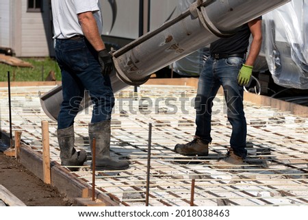 Workers getting ready to pour concrete in a patio floor