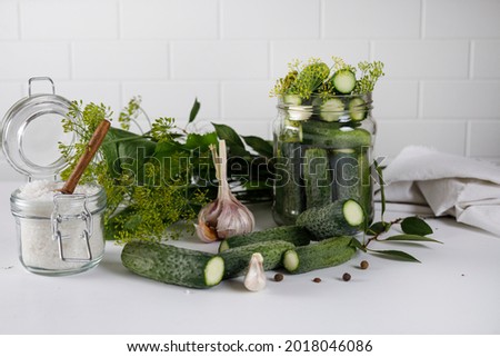 a jar of cucumbers on the table with ingredients for pickles. Jar top view with cucumbers. Photo of cucumbers. Preparations for the winter