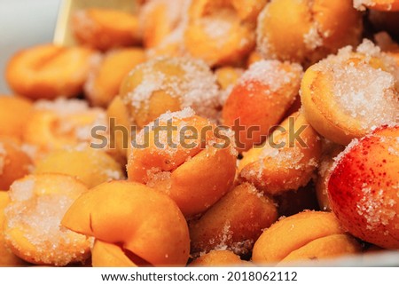 Juicy ripe red and red natural apricots whole and halves lie in white sugar prepared for cooking delicious healthy jam