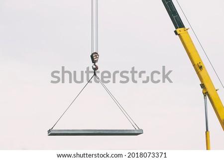 The building crane lifting the concrete plate Royalty-Free Stock Photo #2018073371