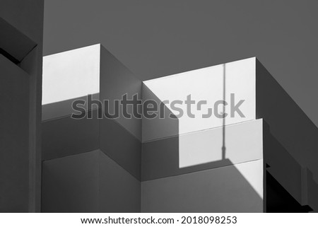 Modern house Building with Sunlight and Shadow on cement wall surface in Perspective low angle view, Abstract Architecture background in Black and White style