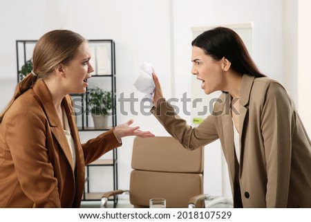 Emotional colleagues arguing in office. Toxic work environment Royalty-Free Stock Photo #2018107529