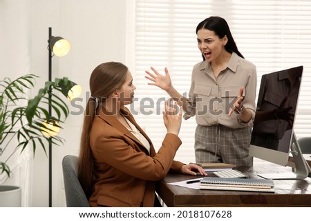Boss screaming at employee in office. Toxic work environment Royalty-Free Stock Photo #2018107628