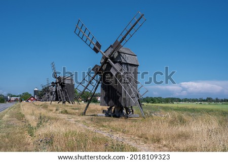 A line of old windmills on a plain. Picture from the Baltic Sea island of Oland