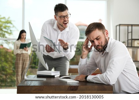 Boss screaming at employee in office. Toxic work environment Royalty-Free Stock Photo #2018130005