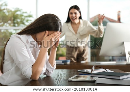 Boss screaming at employee in office. Toxic work environment Royalty-Free Stock Photo #2018130014