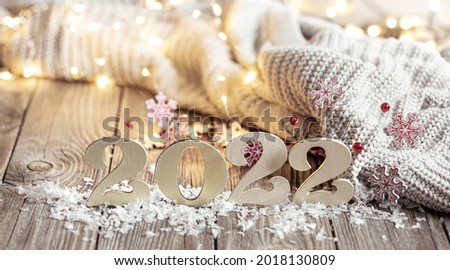 Christmas still life with decorative number of the coming year with decor details on blurred background.