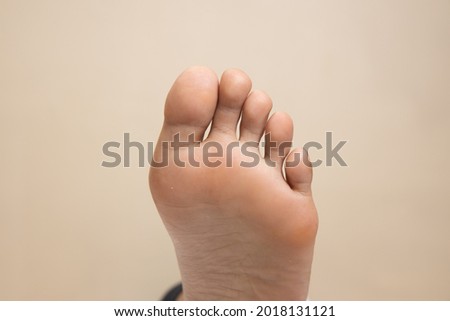 Closeup of a female foot sole
 on a white background