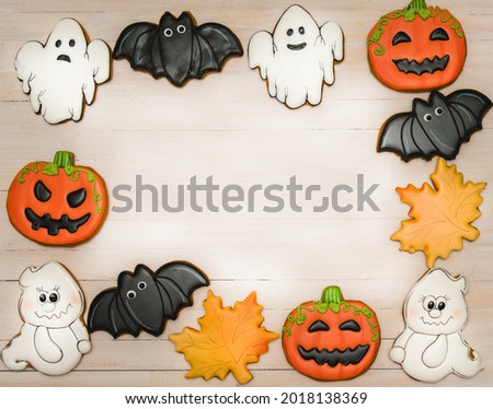Composition of gingerbread halloween characters on wooden background