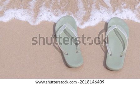 Green slippers on the beach wallpaper